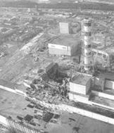 Chernobyl reactor 4 after the disaster, showing the extensive damage to the main reactor hall (image center) and turbine building (image lower left)