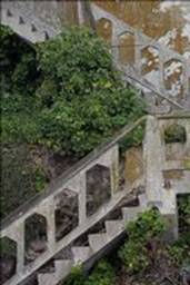 Weathered staircase climbing hill from dock to Alcatraz prison at top of hill
