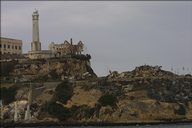 Alcatraz prison island viewed from ferry, prison building to left of lighthouse